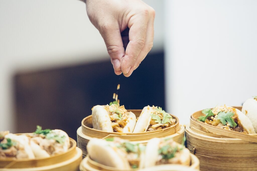 Detail of the hand of a chef preparing tapas